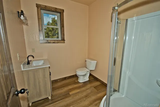a bathroom with a glass shower door