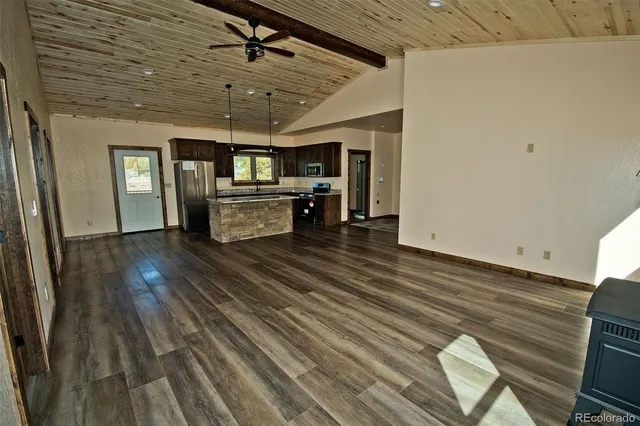 a view of a livingroom with furniture wooden floor and window
