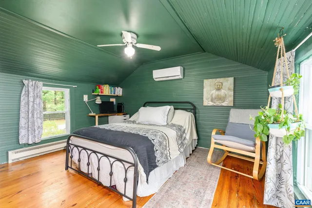 a bedroom with a bed and a potted plant