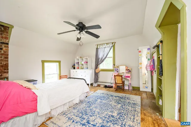 a bedroom with a bed and a mirror