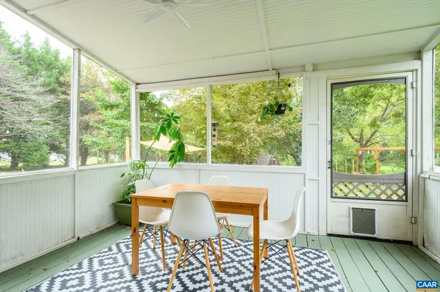 a dining room with a table and chairs