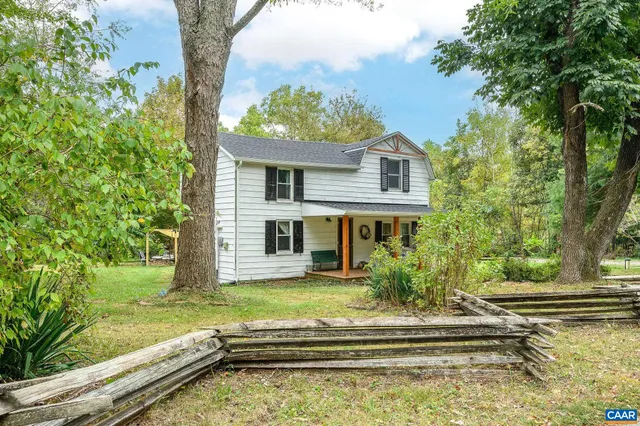 a view of house with a yard