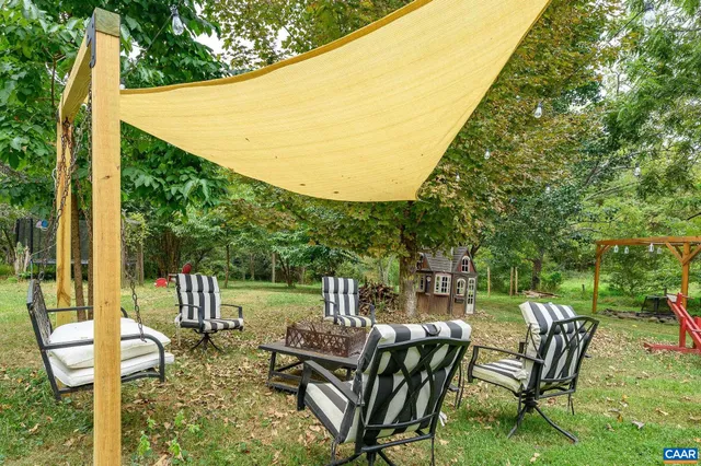 a view of a patio with table and chairs and potted plants
