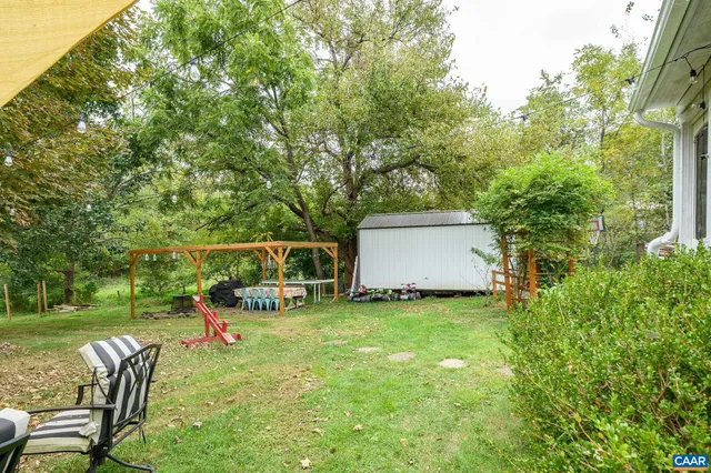 a view of a chair and table in the garden