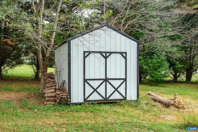 a white house with tree in the background