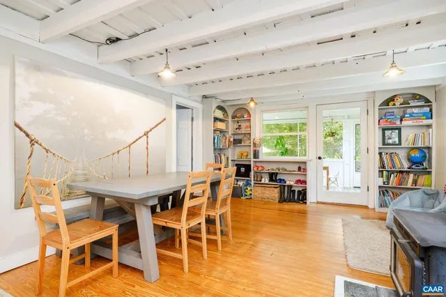 a dining room with stainless steel appliances kitchen island granite countertop a table and chairs in it