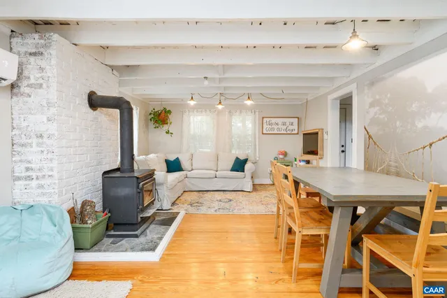 a living room with furniture a rug and a fireplace