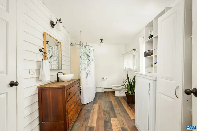 a view of a bathroom with tub and shower