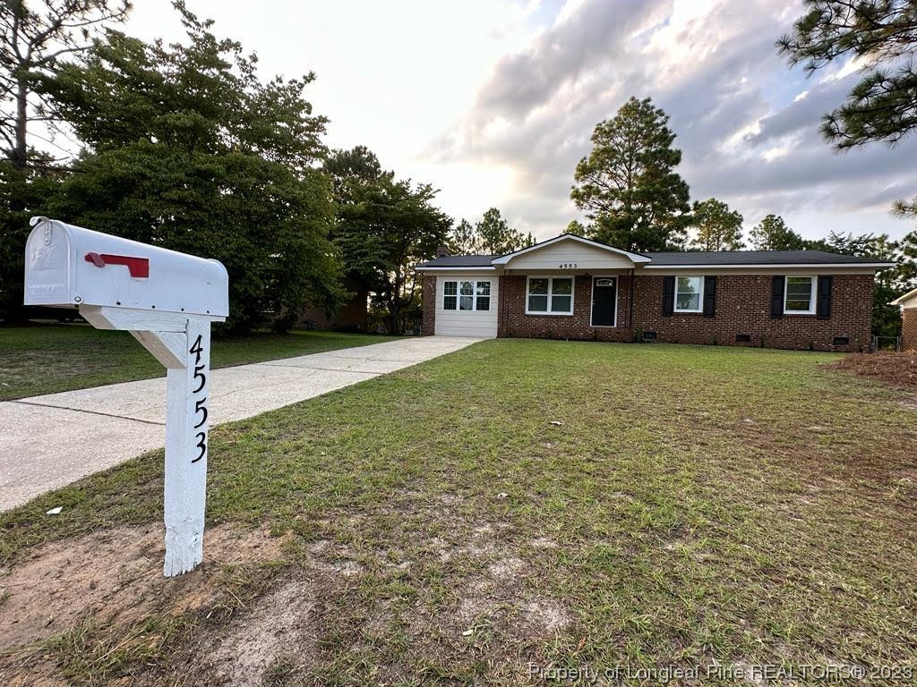 4553 Ruby Road Fayetteville, NC 28311 - Photo 1 of 19 a front view of a house with garden