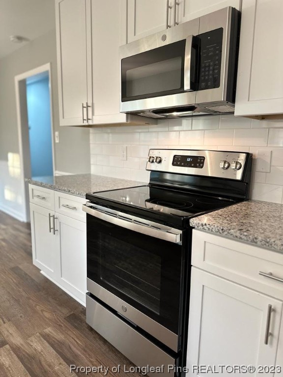4553 Ruby Road Fayetteville, NC 28311 - Photo 12 of 19 a kitchen with stainless steel appliances granite countertop a stove microwave and oven