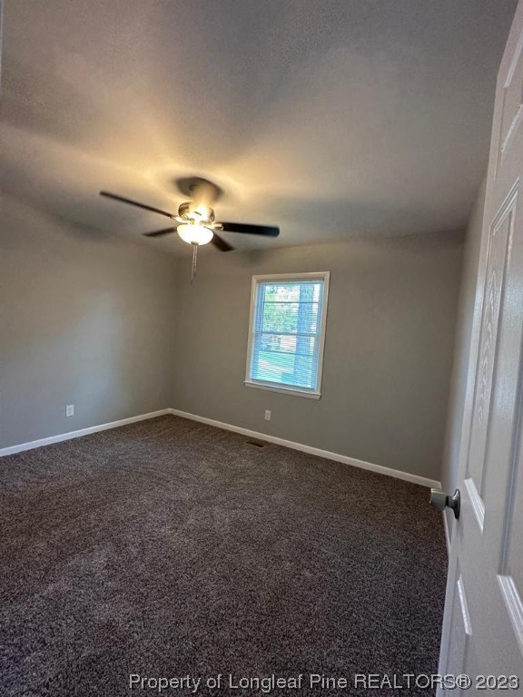 4553 Ruby Road Fayetteville, NC 28311 - Photo 14 of 19 an empty room with windows and fan