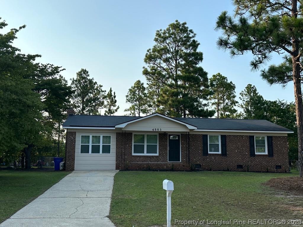 4553 Ruby Road Fayetteville, NC 28311 - Photo 16 of 19 a front view of a house with a garden