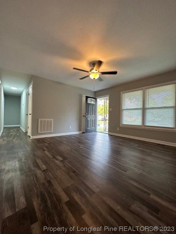 4553 Ruby Road Fayetteville, NC 28311 - Photo 9 of 19 an empty room with wooden floor and windows