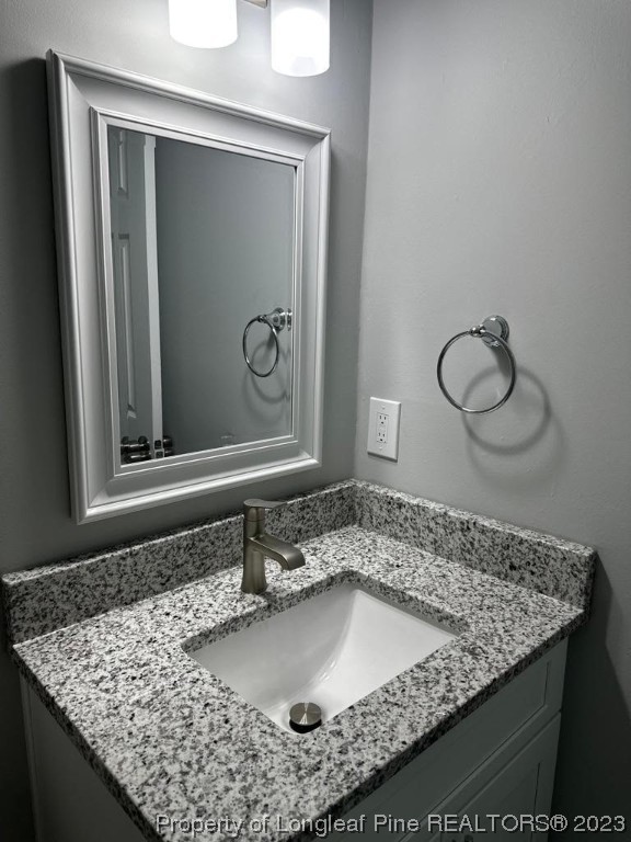 4553 Ruby Road Fayetteville, NC 28311 - Photo 10 of 19 a bathroom with a granite countertop sink and mirror