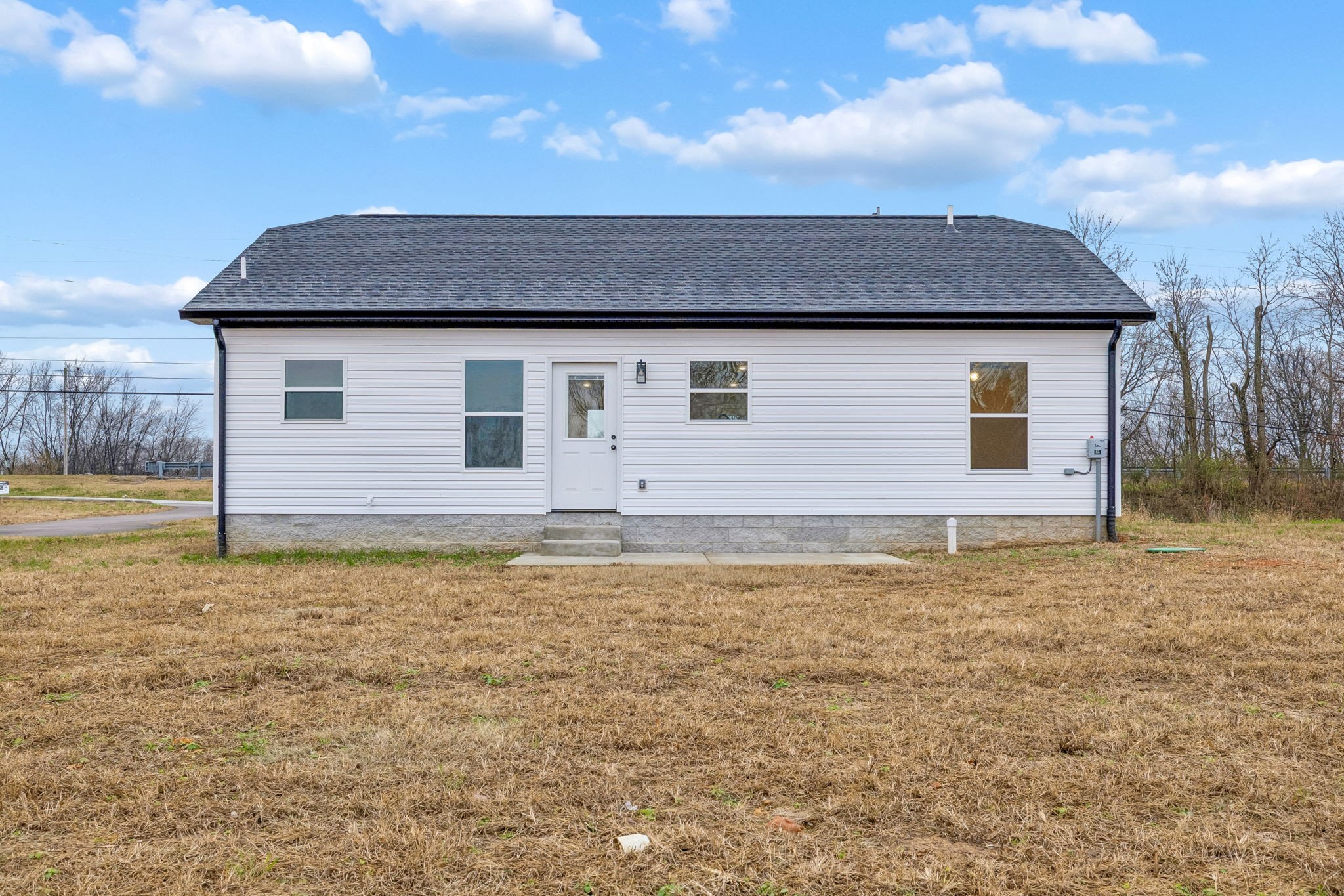1057 Landing Lane Adams, TN 37010 - Photo 25 of 29 a front view of a house with a yard