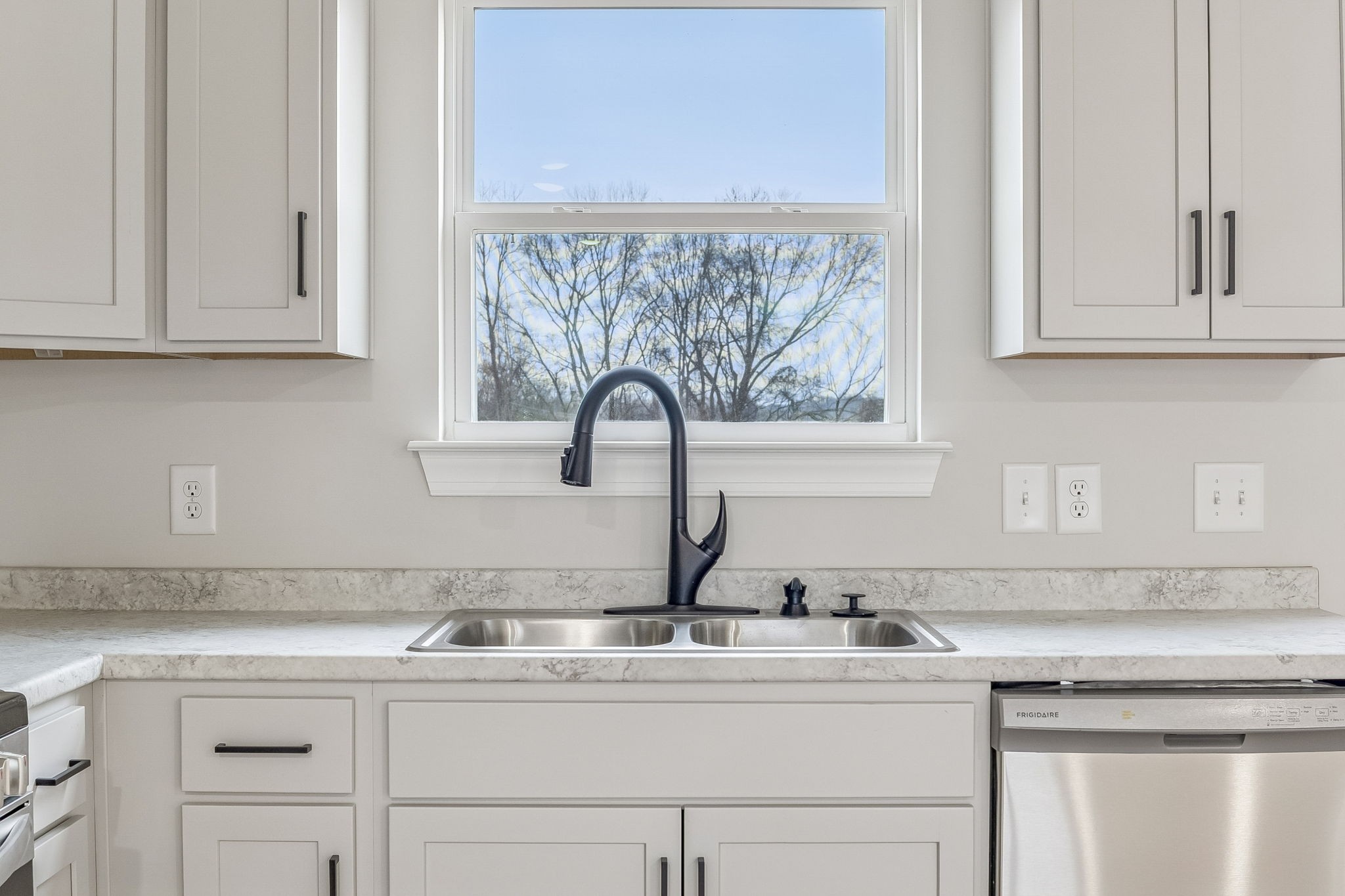 1057 Landing Lane Adams, TN 37010 - Photo 10 of 29 a kitchen with white cabinets and a sink