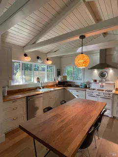 a large kitchen with a table and chairs