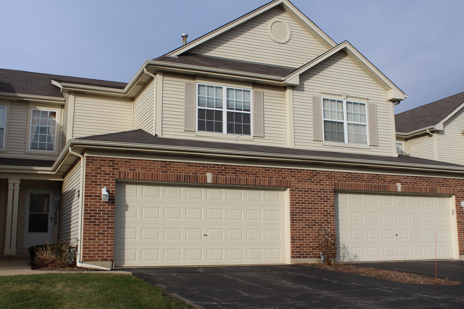 1499 Keystone Court, Unit 423 Elgin, IL 60120 - Photo 1 of 18 a front view of a house with a yard
