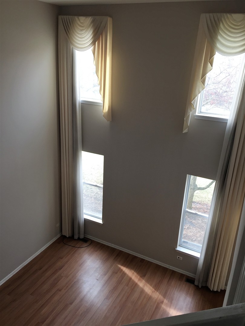 1499 Keystone Court, Unit 423 Elgin, IL 60120 - Photo 12 of 18 an empty room with wooden floor and windows