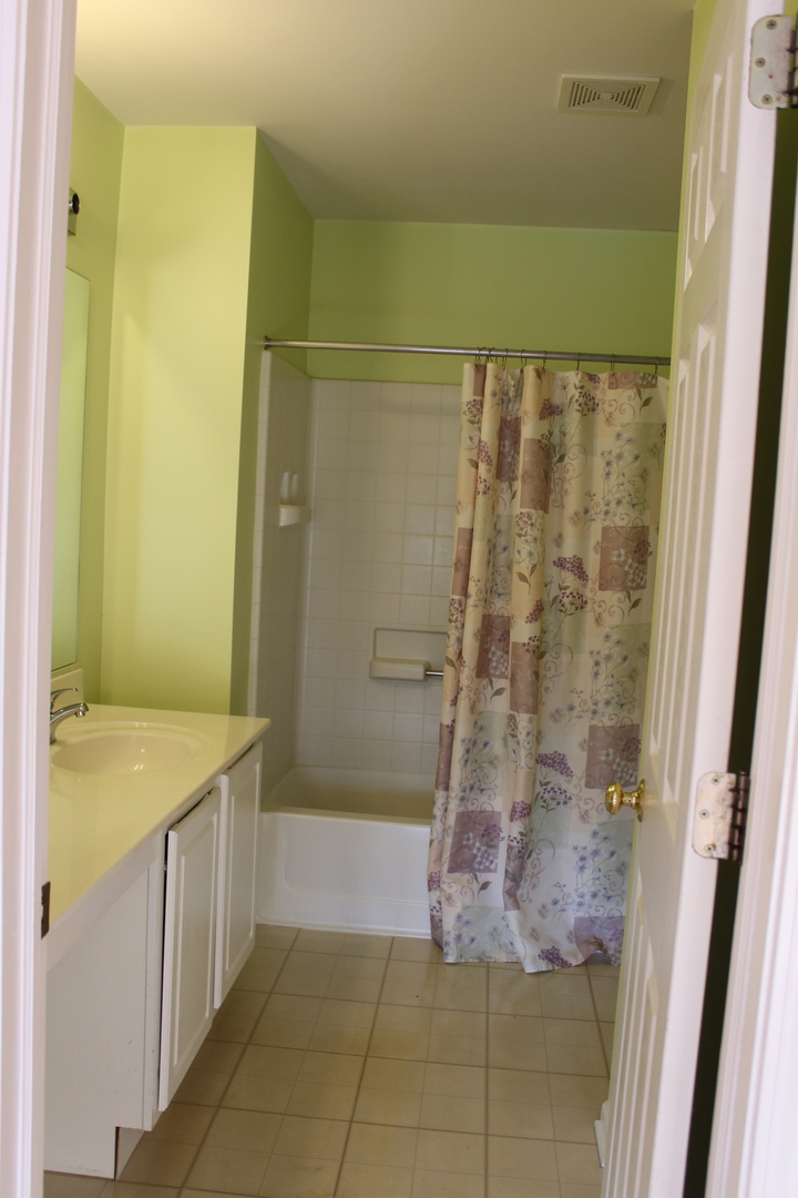 1499 Keystone Court, Unit 423 Elgin, IL 60120 - Photo 15 of 18 a bathroom with a granite countertop shower and a sink