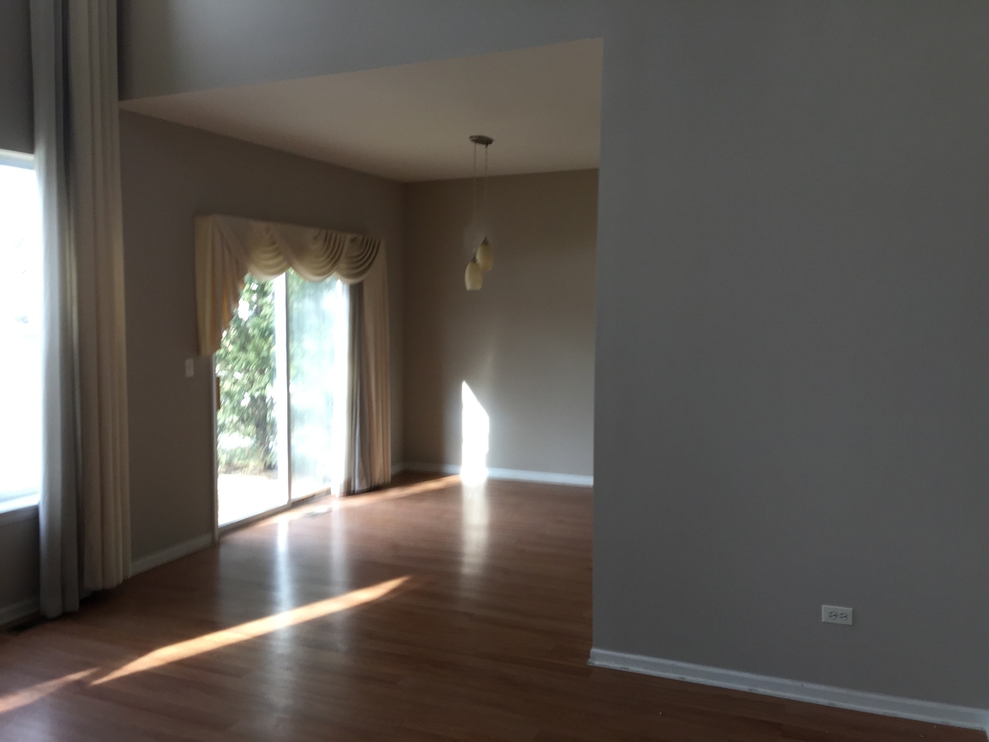 1499 Keystone Court, Unit 423 Elgin, IL 60120 - Photo 4 of 18 a view of an empty room with wooden floor and a window
