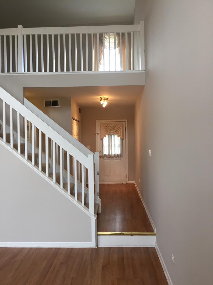 1499 Keystone Court, Unit 423 Elgin, IL 60120 - Photo 5 of 18 a view of entryway and hall with wooden floor