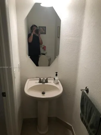 a bathroom with a sink and mirror