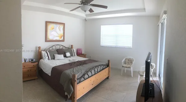 a bed room with a bed and a chandelier