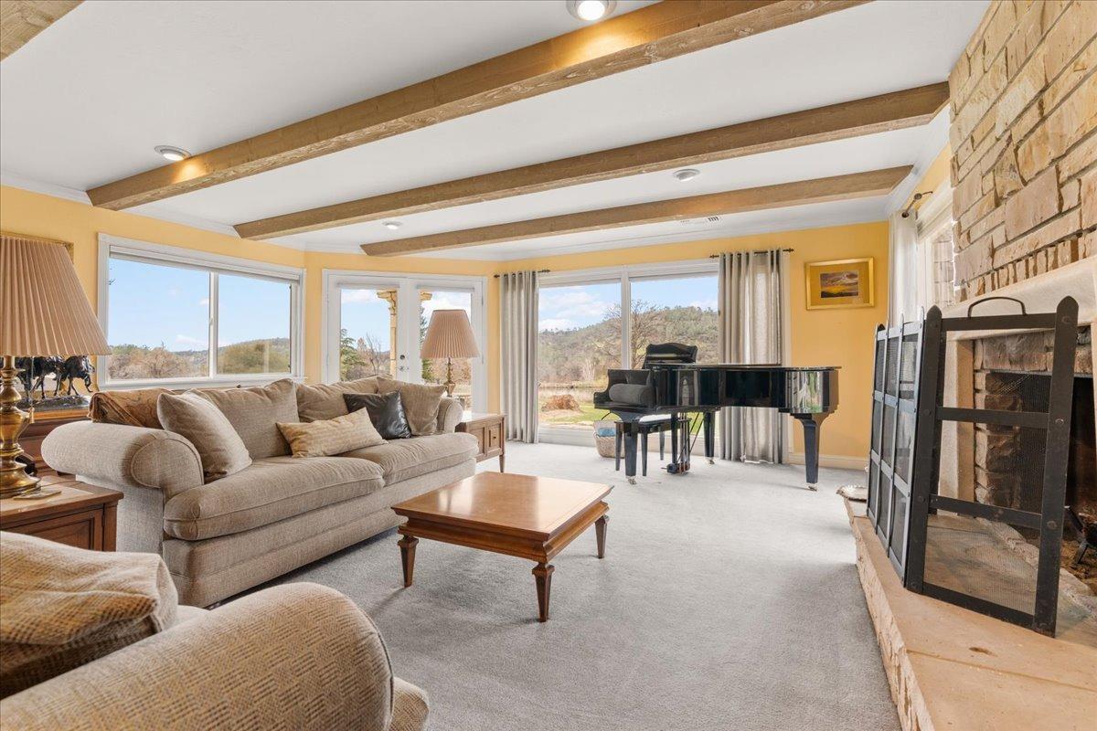 6525 Curtola Ranch Road Auburn, CA 95602 - Photo 15 of 49 Living room with fireplace and views of the pond