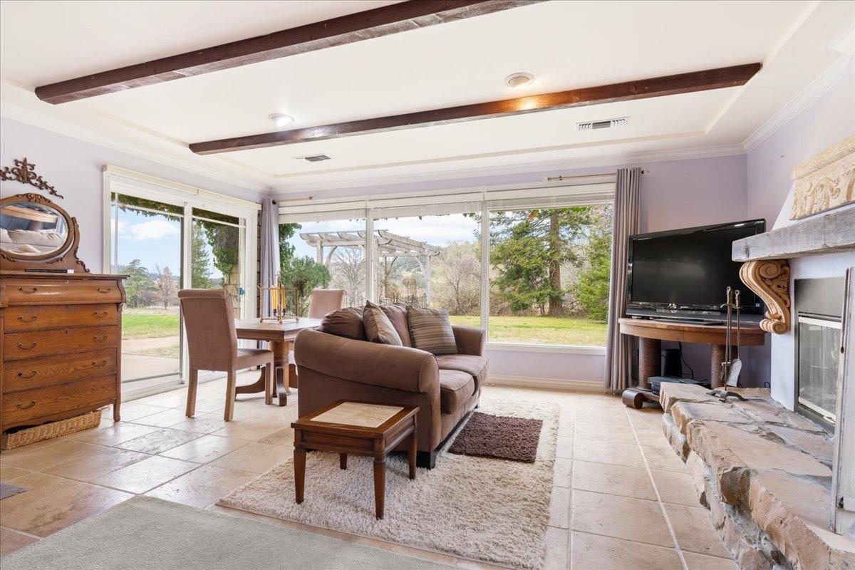 6525 Curtola Ranch Road Auburn, CA 95602 - Photo 23 of 49 Primary Suite sitting area with fireplace and walk out to patio and views of the pond.