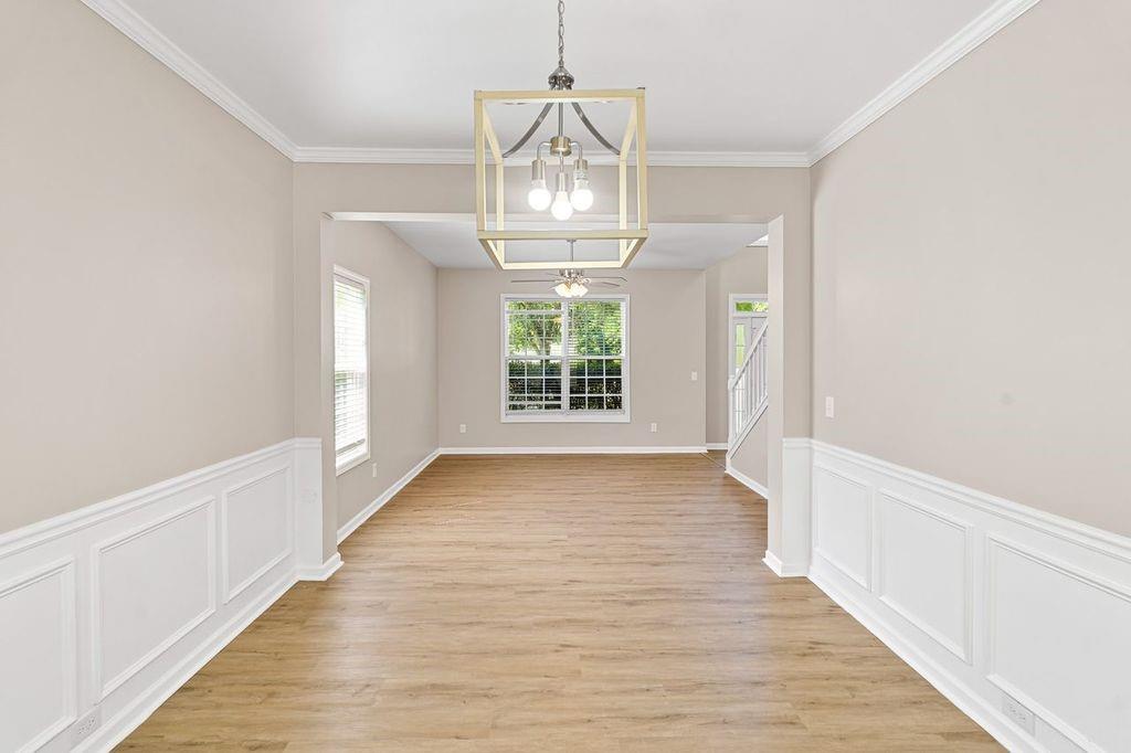 473 Greyhawk Way Fairburn, GA 30213 - Photo 6 of 34 a view of an empty room with wooden floor and a window