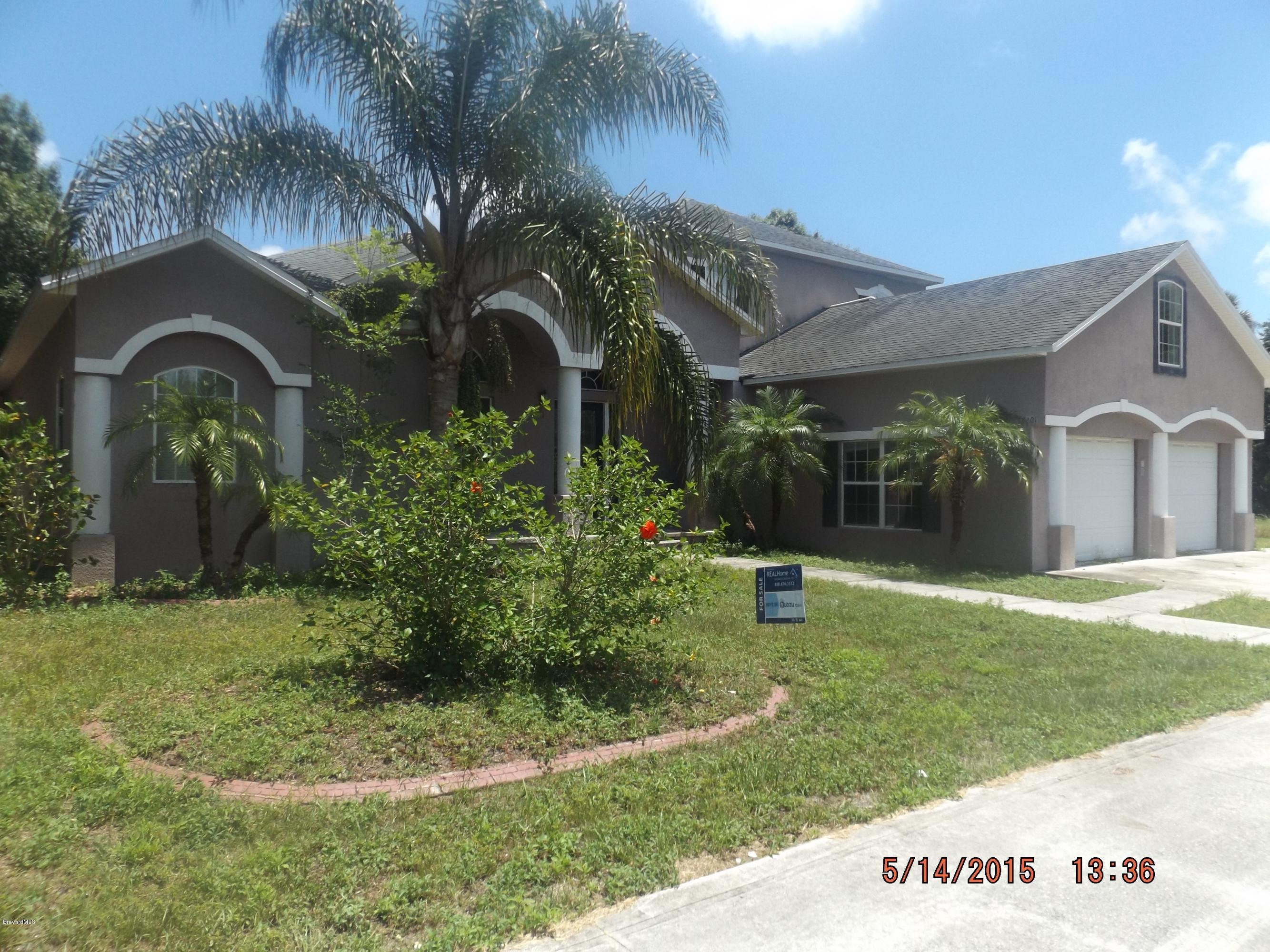 3201 Aurora Road Melbourne, FL 32934 - Photo 1 of 18 a front view of a house with garden