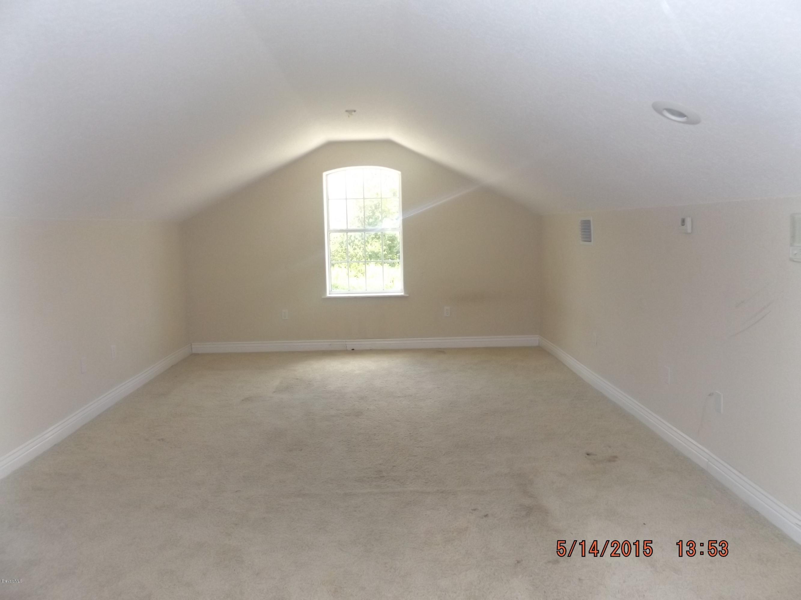 3201 Aurora Road Melbourne, FL 32934 - Photo 14 of 18 an empty room with a window