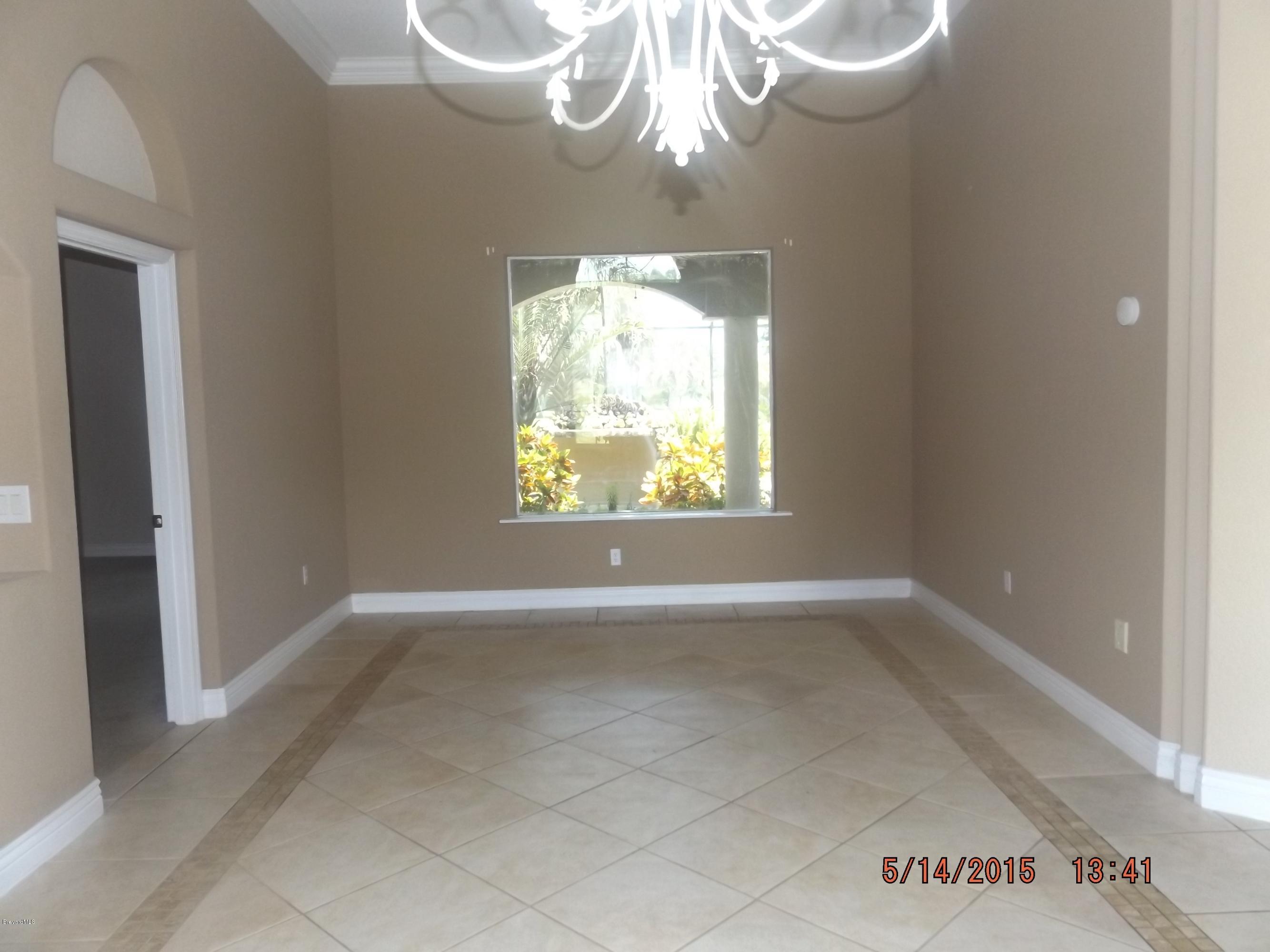 3201 Aurora Road Melbourne, FL 32934 - Photo 3 of 18 an empty room that has a window
