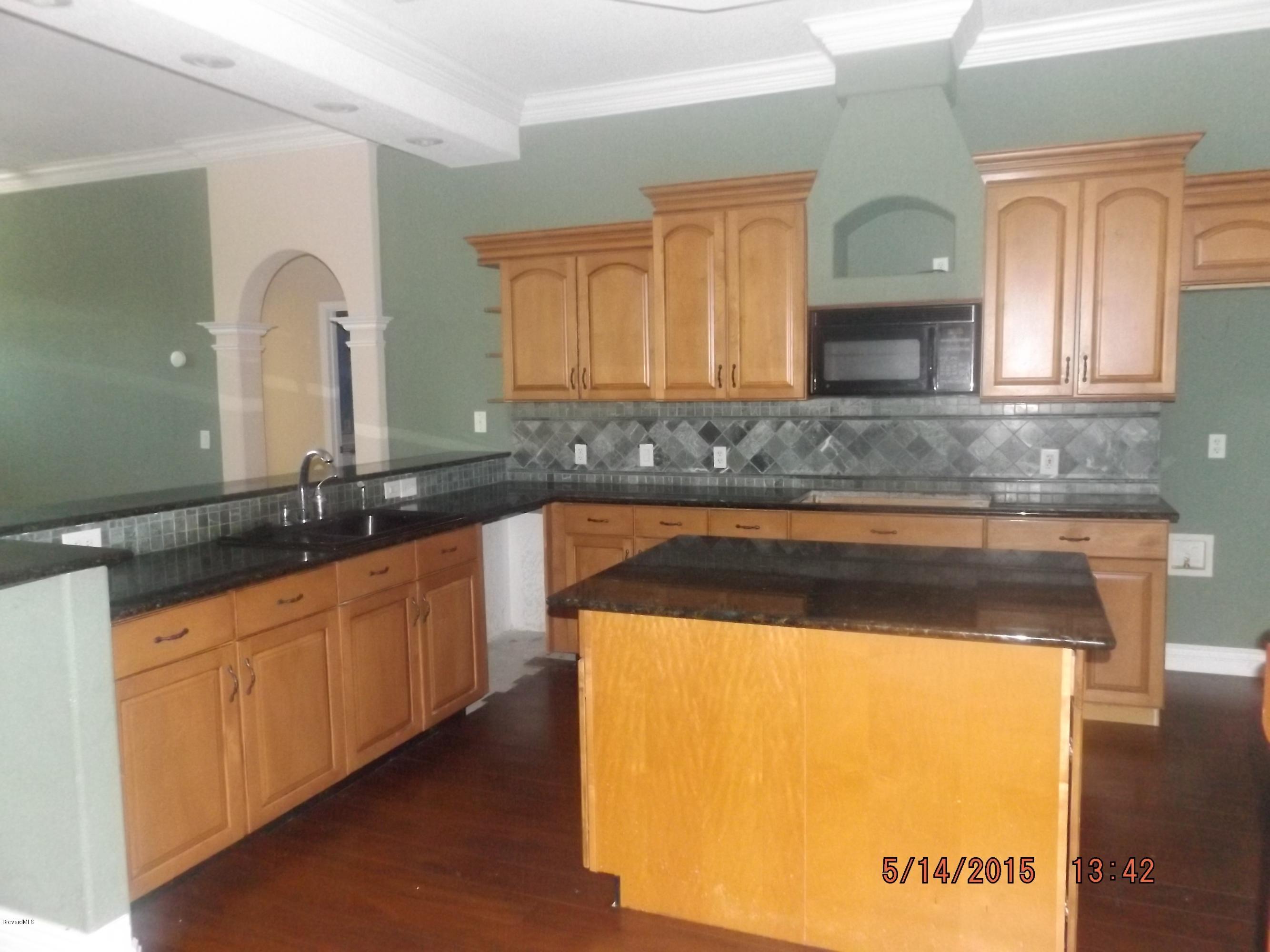 3201 Aurora Road Melbourne, FL 32934 - Photo 5 of 18 a bathroom with a granite countertop sink and a mirror