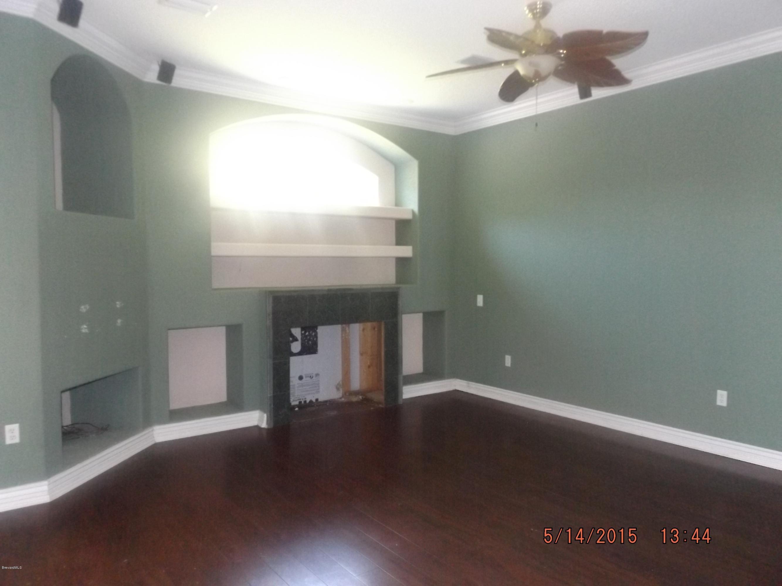 3201 Aurora Road Melbourne, FL 32934 - Photo 7 of 18 an empty room with wooden floor and windows