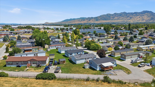 433 North 750 West Logan, UT 84321 - Photo 33 of 40 Community setting featuring multiple manufactured homes and paved roadways, with distant mountains providing a scenic backdrop