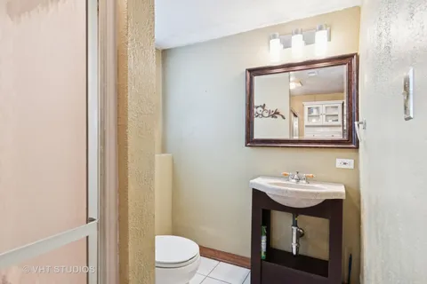 a bathroom with a toilet a sink and mirror