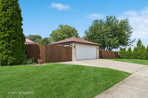 a front view of house with backyard and trees