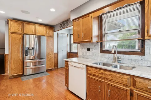 a kitchen with stainless steel appliances granite countertop a refrigerator and a sink