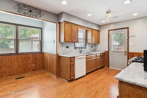 a kitchen with a stove a sink and a refrigerator