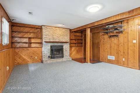 a view of an empty room with a fireplace