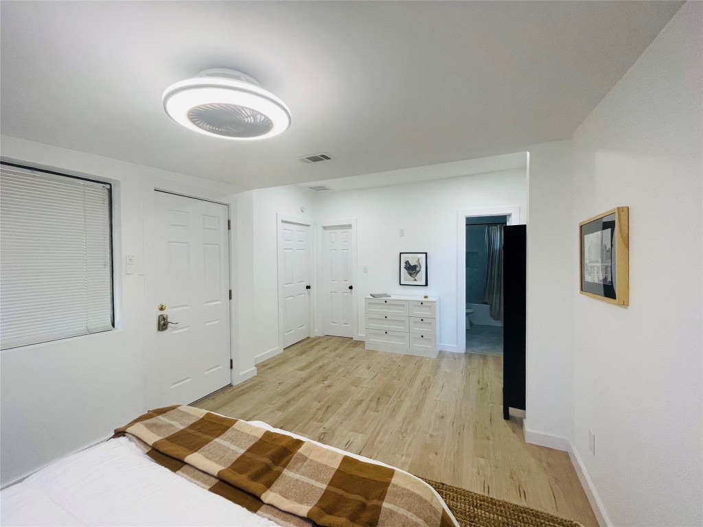 1403 Newfield Lane Austin, TX 78703 - Photo 16 of 34 a bedroom with a bed and painting on the wall