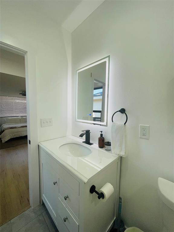 1403 Newfield Lane Austin, TX 78703 - Photo 17 of 34 a bathroom with a sink and a mirror