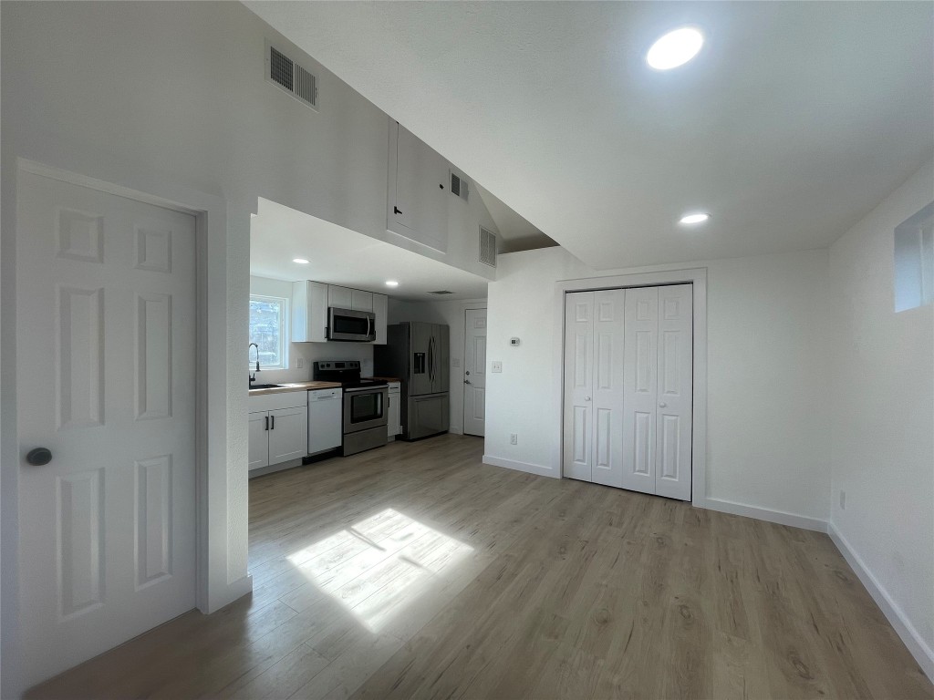 1403 Newfield Lane Austin, TX 78703 - Photo 25 of 34 a view of a kitchen with a sink and a refrigerator
