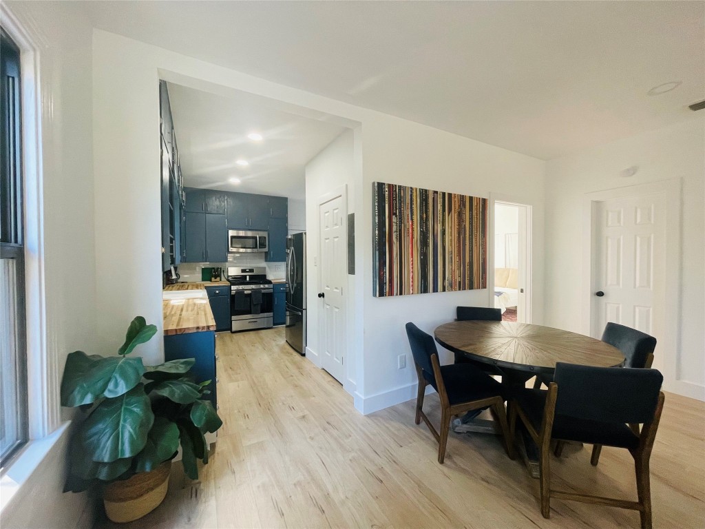 1403 Newfield Lane Austin, TX 78703 - Photo 8 of 34 a view of a dining room with furniture and wooden floor