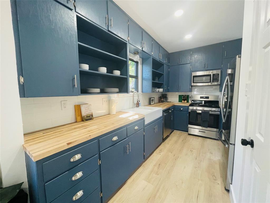 1403 Newfield Lane Austin, TX 78703 - Photo 9 of 34 a kitchen with a sink window and cabinets