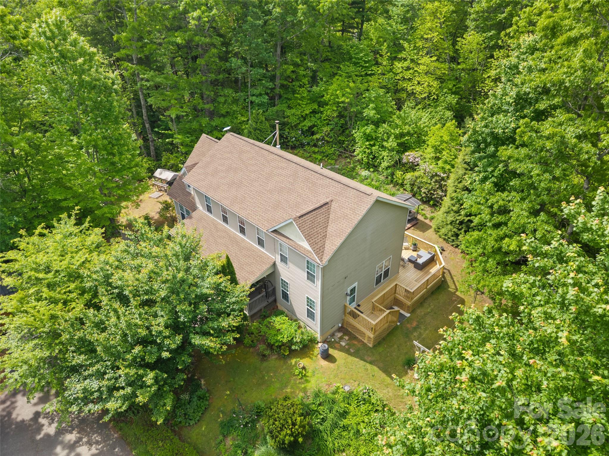 103 Old Southside Road Saluda, NC 28773 - Photo 5 of 48 an aerial view of a house with a yard and trees all around