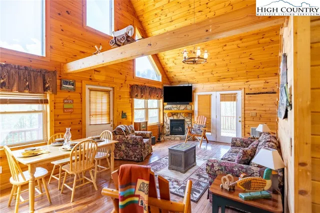 a living room with fireplace furniture and a large window