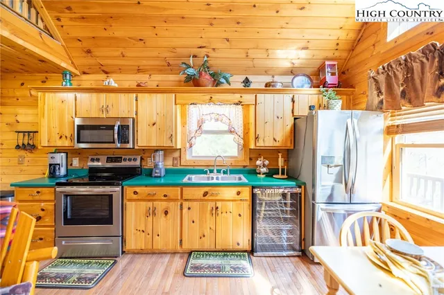 a kitchen with stainless steel appliances granite countertop a stove and a refrigerator